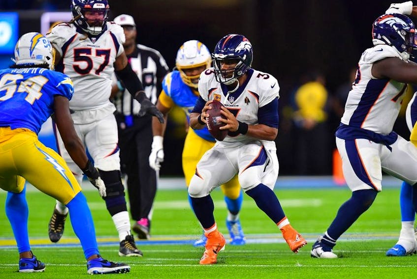 Oct 17, 2022; Inglewood, California, USA; Denver Broncos quarterback Russell Wilson (3) runs the ball against the Los Angeles Chargers during the second half at SoFi Stadium.  