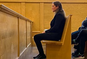 Corner Brook RNC officer Noelle Laite sits with her eyes closed as she waits for her trial to resume in provincial court in Corner Brook on Thursday (Oct. 27). - Diane Crocker/SaltWire Network