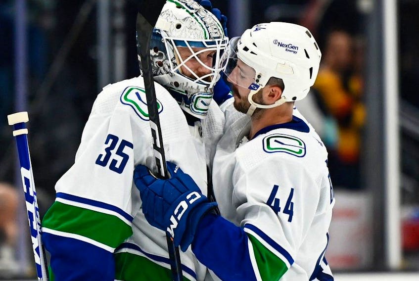  Vancouver Canucks goaltender Thatcher Demko (35) and defenseman Kyle Burroughs (44) celebrate after defeating the Seattle Kraken at Climate Pledge Arena. Vancouver defeated Seattle 5-4. Photo: Steven Bisig-USA TODAY Sports