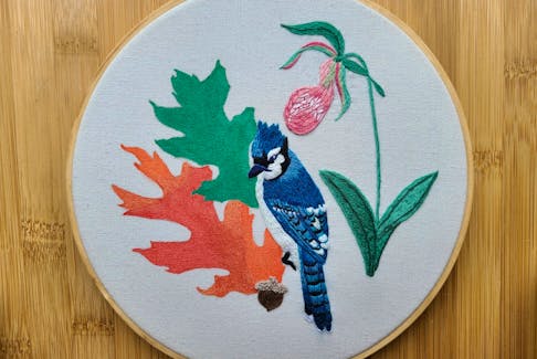 Natalie Newcombe, of Sacred Cottage Creations, is creating an embroidered series that showcases the official birds, trees, and flowers for each province or territory in Canada. Pictured here is her tribute to P.E.I., which features a blue jay, lady’s slipper, and red oak.