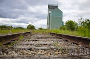  Railroad tracks by a grain elevator in Alberta.
