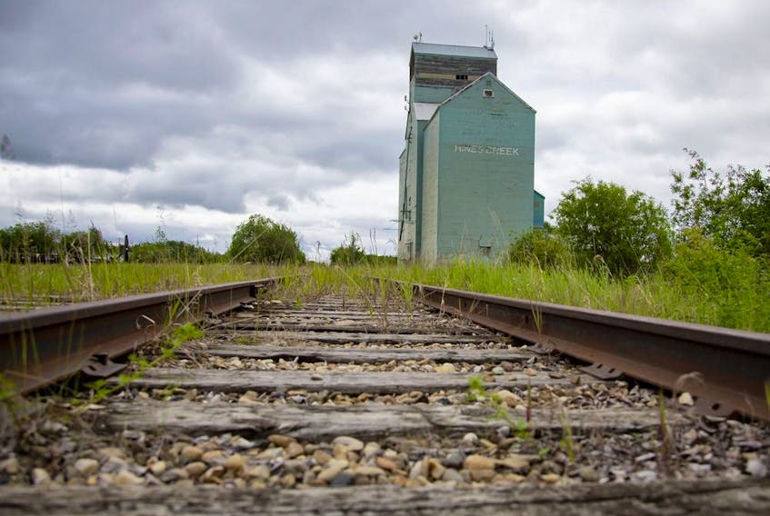  Railroad tracks by a grain elevator in Alberta.