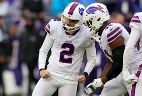 Tyler Bass #2 and Reggie Gilliam #41 of the Buffalo Bills celebrate after Bass kicked a field goal in the fourth quarter to beat the Baltimore Ravens.