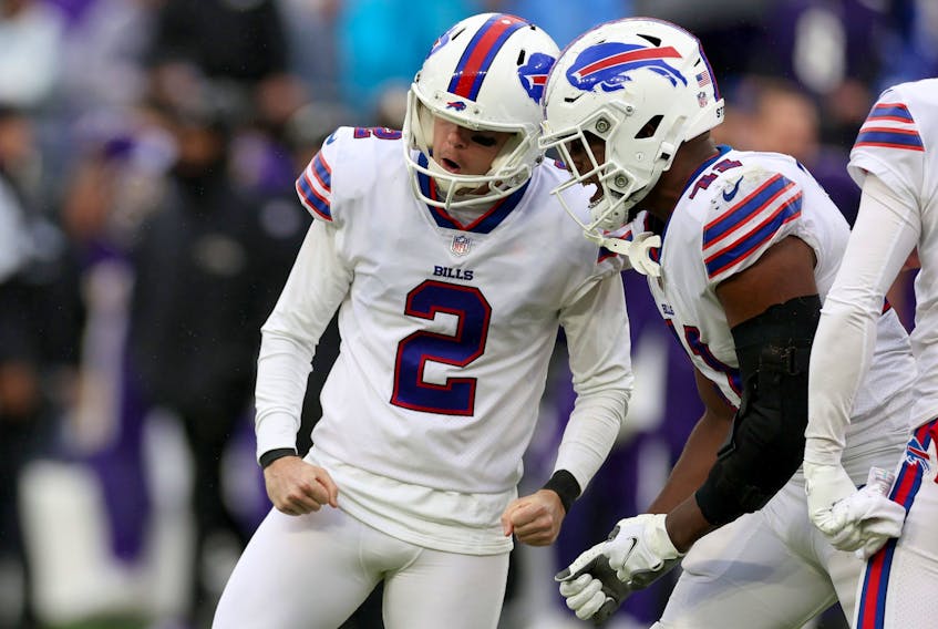 Tyler Bass #2 and Reggie Gilliam #41 of the Buffalo Bills celebrate after Bass kicked a field goal in the fourth quarter to beat the Baltimore Ravens.