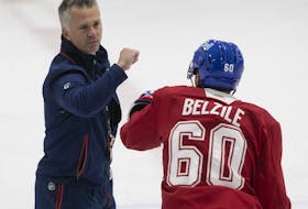 Montreal Canadiens head coach Martin St-Louis pumps fists with Alex Belzile during first day of training camp in Brossard on Thursday September 22, 2022.