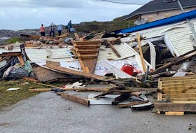Folks walk in the opposite direction of some of the destruction wreaked by Hurricane Fiona in Burnt Islands on Newfoundland’s southwest coast. Photo via Facebook