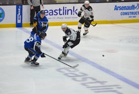 Saint John Sea Dogs defenceman Charlie DesRoches, 58, defends against Charlottetown Islanders forward Michael Horth, 27, during a Quebec Major Junior Hockey League game at Eastlink Centre in Charlottetown during the 2021-22 season. The Sea Dogs recently named DesRoches, from Days Corner, P.E.I., as team captain. Jason Simmonds • Journal Pioneer