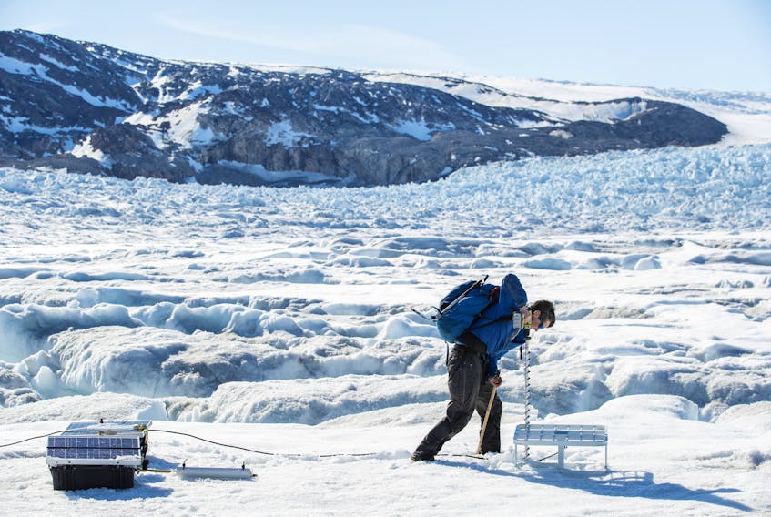 Safety officer Brian Rougeux uses a drill to install antennas for scientific instruments that will be left on top of the Helheim glacier near Tasiilaq, Greenland, June 19, 2018. REUTERS/Lucas Jackson  SEARCH "JACKSON GREENLAND" FOR THIS STORY. SEARCH "WIDER IMAGE" FOR ALL STORIES.  Safety officer Brian Rougeux uses a drill to install antennas for scientific instruments that will be left on top of the Helheim glacier near Tasiilaq, Greenland on June 19, 2018. A small group of scientists are now looking into ways to slow down the rate of glacial melt, which contributes to rising sea levels. REUTERS file photo/Lucas Jackson
