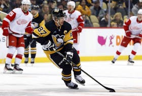 Sep 27, 2022; Pittsburgh, Pennsylvania, USA;  Pittsburgh Penguins center Sidney Crosby (87) handles the puck against the Detroit Red Wings during the first period at PPG Paints Arena.  