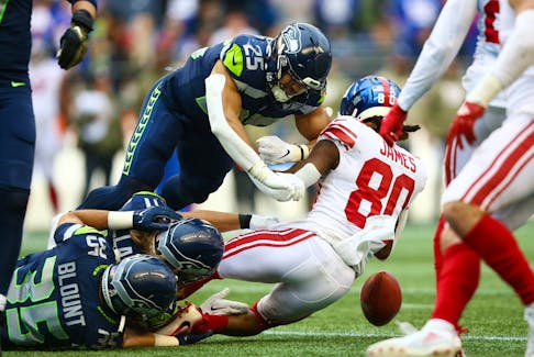 Richie James of the New York Giants fumbles a punt return against the Seattle Seahawks.