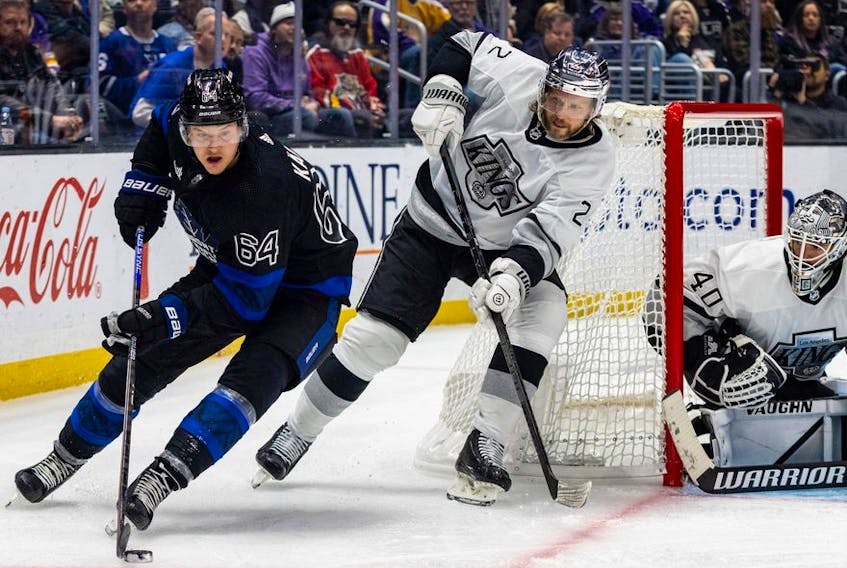 Oct 29, 2022; Los Angeles, California, USA; Toronto Maple Leafs center David Kampf (64) controls the puck in front of Los Angeles Kings left wing Kevin Fiala (22) and goaltender Cal Petersen (40) during the 3rd period at Crypto.com Arena. The Kings won 4-2.  