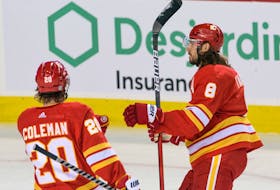 Calgary Flames defenceman Chris Tanev celebrates a goal against the Seattle Kraken with forward Blake Coleman at Scotiabank Saddledome in Calgary on Monday, Oct. 3, 2022.