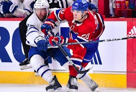 Leafs and Canadiens' Juraj Slafkovsky, right, battles with Leafs defenceman Morgan Rielly Monday night at the Bell Centre.