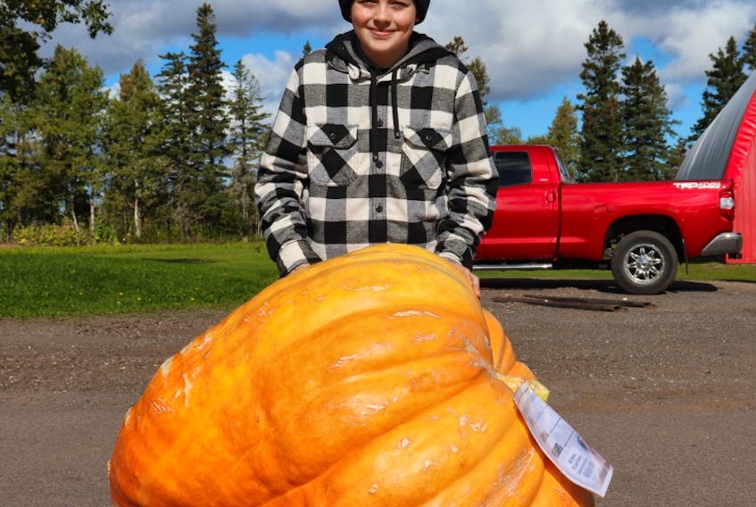 Harrison Yeo stands in front of the giant pumpkin he and his brother, Will, grew together. It placed 9th in the the giant pumpkin weigh-off on Oct. 9, 2021 in York, P.E.I. File