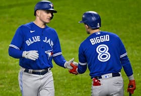 Blue Jays' Matt Chapman, left, celebrates with Cavan Biggio after scoring in the second inning against the Orioles at Oriole Park at Camden Yards in Baltimore, Monday, Oct. 3, 2022.