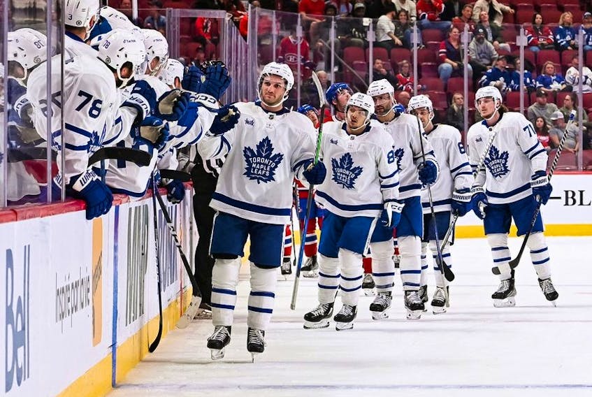 Oct 3, 2022; Montreal, Quebec, CAN; Toronto Maple Leafs center Alexander Kerfoot celebrates his second goal of the game with his teammates at the bench during the third period at Bell Centre. 