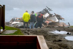Residents of Port aux Basques stand near a destroyed home in the town on Wednesday, Sept. 28 following Hurricane Fiona.

Keith Gosse/The Telegram