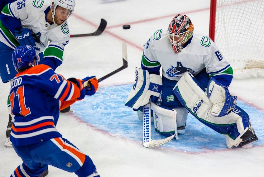 Edmonton Oilers Ryan McLeod shoots the puck by the Vancouver Canucks goalie Collin Delia during first period pre-season action on Monday, Oct. 3, 2022 in Edmonton. 