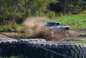 A truck makes its way through some mud at the track at Real Canadian Recreation.