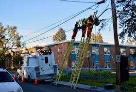 Telecom workers fix fallen lines outside Prince Street School Oct. 4. Alison Jenkins • The Guardian