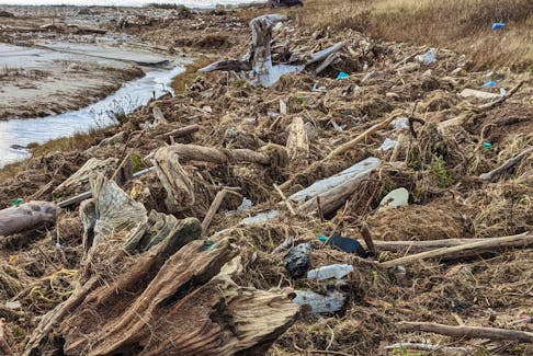 It’s among this pile of debris near Patricia Cousins’ cabin at Rocky Barachois outside of Port aux Basques that she found a message in a bottle that had been tossed into the ocean 39 years ago. – Contributed