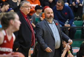 Longtime Cape Breton Capers women’s basketball team coaching duo Fabian McKenzie, left, and Doug Connors are shown discussing a play during Atlantic University Sport action at Sullivan Field House in Sydney. McKenzie and Connors have been coaching together for 24 years and last weekend earned their 400th career victory together. CONTRIBUTED/VAUGHAN MERCHANT, CBU ATHLETICS