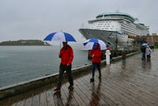 Passengers that have disembarked from one of the 4 visiting cruise ships, huddle beneath umbrellas as they walk down the waterfront during a morning monsoon, in Halifax Thursday Oct 6, 2022. Over 10,000 passengers were expected to visit the city on this extremely wet afternoon. 

TIM KROCHAK PHOTO