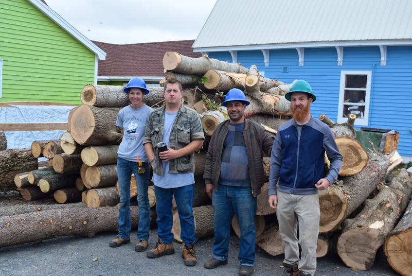 A team working to restore the Ship Hector gathered up fallen logs to use in the project after Fiona. From left are: Catherline Love, Alex MacDonald, Yasser Alalrra and William Larmour.