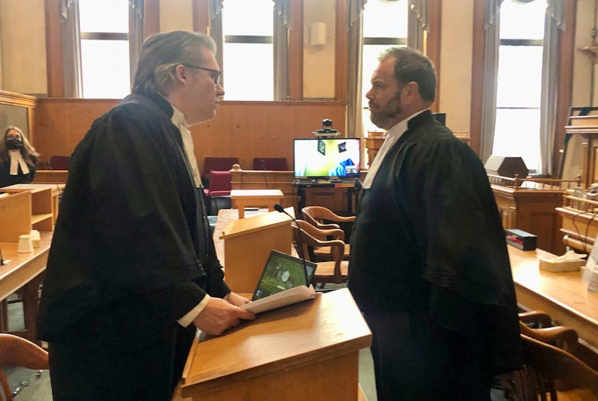 Defence lawyer Mark Gruchy (left) and prosecutor Trevor Bridger chat after the trial of James Curran, Wayne Johnson and Vince Leonard Sr. adjourned for the day in Newfoundland and Labrador Supreme Court in St. John's Thursday, Oct. 5.