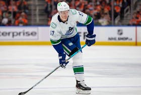 Tyler Myers #57 of the Vancouver Canucks skates against the Edmonton Oilers during the third period at Rogers Place on October 13, 2021 in Edmonton, Canada.