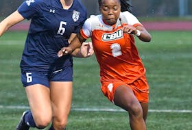 Senate Letsie of the Cape Breton Capers challenges Emma Steen, left, of the St. Francis X-Women in Atlantic University Sport soccer play at Ness Timmons Field in Sydney, Thursday. The X-Women won the game 3-1. PHOTO CONTRIBUTED/VAUGHAN MERCHANT, CBU ATHLETICS.
