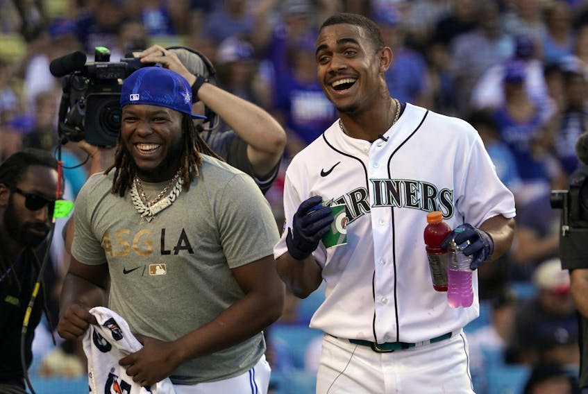 Blue Jays’ Vlad Guerrero Jr. (left) and Mariners’ Julio Rodriguez, sharing a laugh at the All-Star Home Run Derby in July, carry high expectations in this wild-card series for their respective teams. 