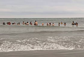 Participants in a "Win Hof" cold-water immersion program take a dip at Rainbow Haven beach in Cole Harbour on Saturday, Oct. 8, 2022.