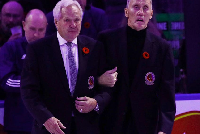 Darryl SIttler (left) and Borje Salming walk out for ceremonies prior to the Toronto Maple Leafs against the Pittsburgh Penguins at the Scotiabank Arena.