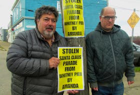 Alan Nathanson, left, president of the Whitney Pier Group Society, with volunteer Drew MacDonald, place signs up accusing the CBRM mayor for allegedly ignoring Whitney Pier residents and their concerns with not including the neighbourhood as part of a Santa Claus parade route. IAN NATHANSON/CAPE BRETON POST