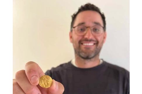 Newfoundland metal detectorist Ed Hynes is pictured with his recent incredible discovery: a gold Henry VI quarter noble, minted in London between 1422 and 1427 and believed to be the oldest English coin ever found in Canada.