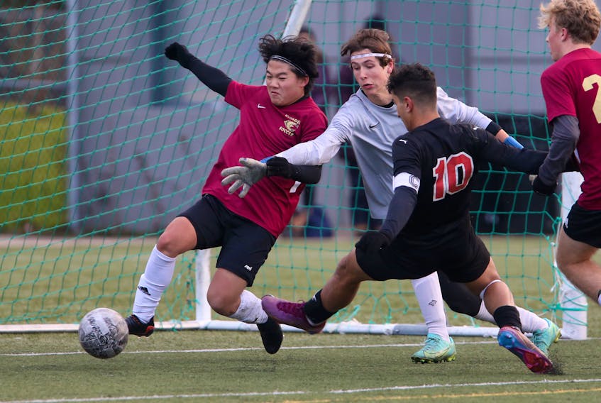 Halifax West's Moe Wahdan (10) slips the ball past Halifax Citadel David Wigfrivs  (sp) and keeper Emmett Workman for a goal during the first half of the provincial high school final at CP Allan in Bedford Monday November 13, 2022. 

TIM KROCHAK PHOTO