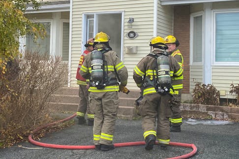 Firefighters enter a home on Jasper Street in St. John's where a piece of machinery caught fire.