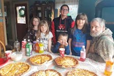Katie Mason says her family's "unconventional" Christmas pizza meal began at the request of her children. It has the added benefit of letting her relax and watch them open presents on Christmas morning instead of spending her time in the kitchen. - Contributed
