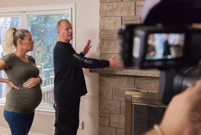 Mike Holmes and Sherry discuss a homeowner’s wood-burning fireplace from Holmes and Holmes, Season 2. 