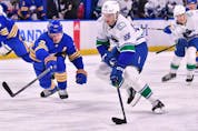  Vancouver Canucks centre Nils Aman (88) moves the puck past Buffalo Sabres defenceman Rasmus Dahlin (26) in the first period at KeyBank Center.