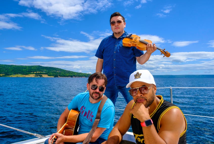 Award-winning Cape Breton musician and producer Keith Mullins, from left, Wagmatcook First Nation fiddling phenom Morgan Toney and Toronto-based rapper D.O. on the set of the video for their single “Getting Back Out East.” All three will perform in Sydney as Nova Scotia Music Week celebrates its 25th anniversary. Contributed