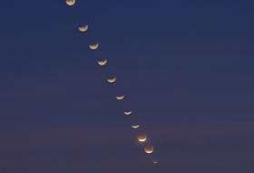 jsc2018e003235 (Jan. 31, 2018) --- Composite photograph created from 13 images of the lunar eclipse through its phases as viewed from the 9th floor of NASA Johnson Space Center’s Building 1.  A composite photograph taken in January 2018 created from 13 images of the lunar eclipse through its phases as viewed from the ninth floor of NASA Johnson Space Center. - NASA