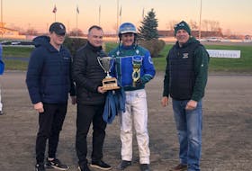 Corey MacPherson won the Paul MacDonald Memorial Driving Championship Nov. 19 at Red Shores Racetrack and Casino at the Charlottetown Driving Park. From left: Paul MacDonald’s grandson Devon, son Danny MacDonald, champion driver Corey MacPherson and James Perrot PEISHOA President. Contributed