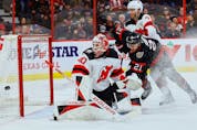  Senators winger Mathieu Joseph battles Devils defenceman Dougie Hamilton for a rebound after goaltender Akira Schmid makes a save during the first period of Saturday’s game at Canadian Tire Centre.