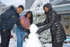 Cape Breton University students, from the left, Akhih Maliakah Varkey, Bincy Sajge George and Anaha Saji, are showing making their first ever snowman after the witnessed their first ever snowfall on Monday. They were quite excited at the opportunity to make the most of their first winter. GREG MCNEIL/CAPE BRETON POST
