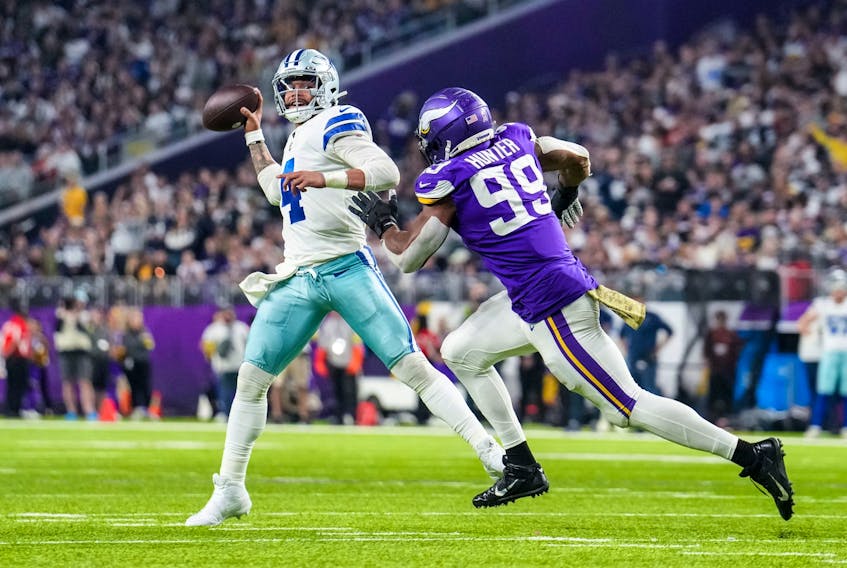 Dallas Cowboys quarterback Dak Prescott (4) throws over Minnesota Vikings linebacker Danielle Hunter (99) during the third quarter at U.S. Bank Stadium. 