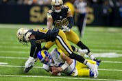  Nov 20, 2022; New Orleans, Louisiana, USA; Los Angeles Rams quarterback Matthew Stafford (9) slides under a tackle by New Orleans Saints cornerback Paulson Adebo (29) in the second quarter at the Caesars Superdome. Mandatory Credit: Chuck Cook-USA TODAY Sports