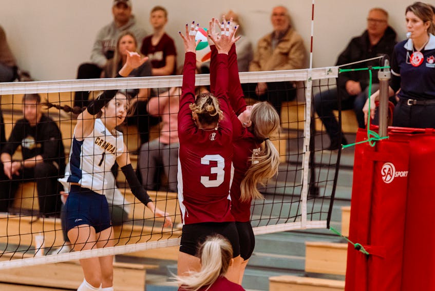 Myah Utrosa (3) and Charlotte Sweetapple (5) go for a block in action against the  Crandall University Chargers on Sunday at the McMillan Centre in Charlottetown. Greg Ellison photo
