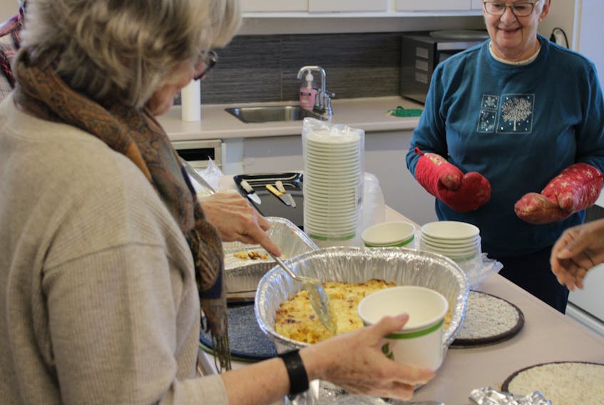 Volunteers taking up food for the community dinner at St. John's Anglican Church on Nov. 19.